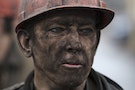 A miner waits for a bus after leaving the Zasyadko coal mine in Donetsk
