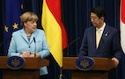 Germany's Chancellor Angela Merkel and Japan's Prime Minister Shinzo Abe attend their joint news conference after talks in Tokyo