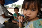 San Smey, 4, eats a piece of roasted rat in the provincial town of Battambang, 290 km (181 miles) no..