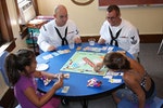 800px-Flickr_-_Official_U.S._Navy_Imagery_-_Sailors_play_board_games_with_children_at_the_Cameron_Community_Ministries_during_Rochester_Navy_Week