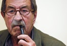 Nobel prize-winning German writer Grass smokes a pipe during a news conference to promote his latest book in Madrid