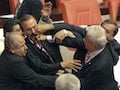 Turkish MPs fight during a debate in the Turkish parliament in Ankara