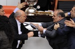Turkey's ruling AK Party lawmaker Muhittin Aksak and main opposition Republican People's Party lawmaker Mahmut Tanal scuffle during a debate at the parliament in Ankara