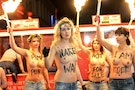 German activists from women's rights organisation Femen hold torches as they demonstrate against prostitution in Herbert-Street in Hamburg's St Pauli red-light district