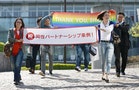Lesbian activists Hiroko Masuhara and her partner Higashi hold a banner after Tokyo's Shibuya ward recognised same-sex partnerships outside the Shibuya city hall in Tokyo
