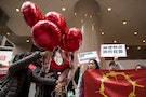 Supporters release balloons with pictures of five detained Chinese female activists during a protest calling for their release in Hong Kong