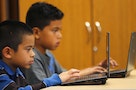 Grade four students work on laptop computers at Monarch School in San Diego, California