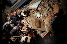 Rescue team member from Nepal, Turkey and china works during the rescue operation to rescue live victims trapped inside the collapsed hotel after an earthquake in Kathmandu