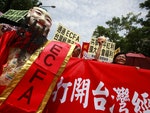 Supporters of the ECFA signed between Taiwan and China celebrate on the streets outside the Legislative Yuan in Taipei