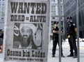 File photo of police standing near a wanted poster of Saudi-born militant Osama bin Laden in New York
