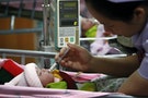 Two-hour old daughter of 17-year old Nakor is fed by a nurse at a hospital in Chiang Mai's Fang district
