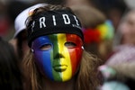 A participant wears a rainbow mask as she attends the Belgian LGBT Pride Parade in Brussels