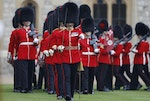 An officer shouts orders as members of the 1st Battalion and No. 7 Company the Coldstream Guards march past the Queen after being presented with their new colours at Windsor Castle, near London