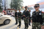 Paramilitary policemen stand guard outside a high school during the national college entrance exam in Zhengzhou