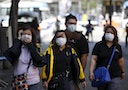Tourists wearing masks to prevent contracting Middle East Respiratory Syndrome (MERS), walk at Myeongdong shopping district in central Seoul