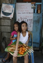 MaryJasmine and MaryAngel sell sweet banana snacks in a squatter colony in Quezon city, Manila