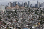 A poor residential district and squatter colonies are overlooked by high rise residential and commercial buildings in Taguig