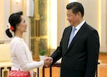 China's President Xi shakes hands with Myanmar pro-democracy leader Aung San Suu Kyi during meeting at Great Hall of People in Beijing