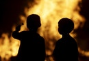 Two children watch a bonfire during the traditional San Juan's night in Paredes, northern Spain