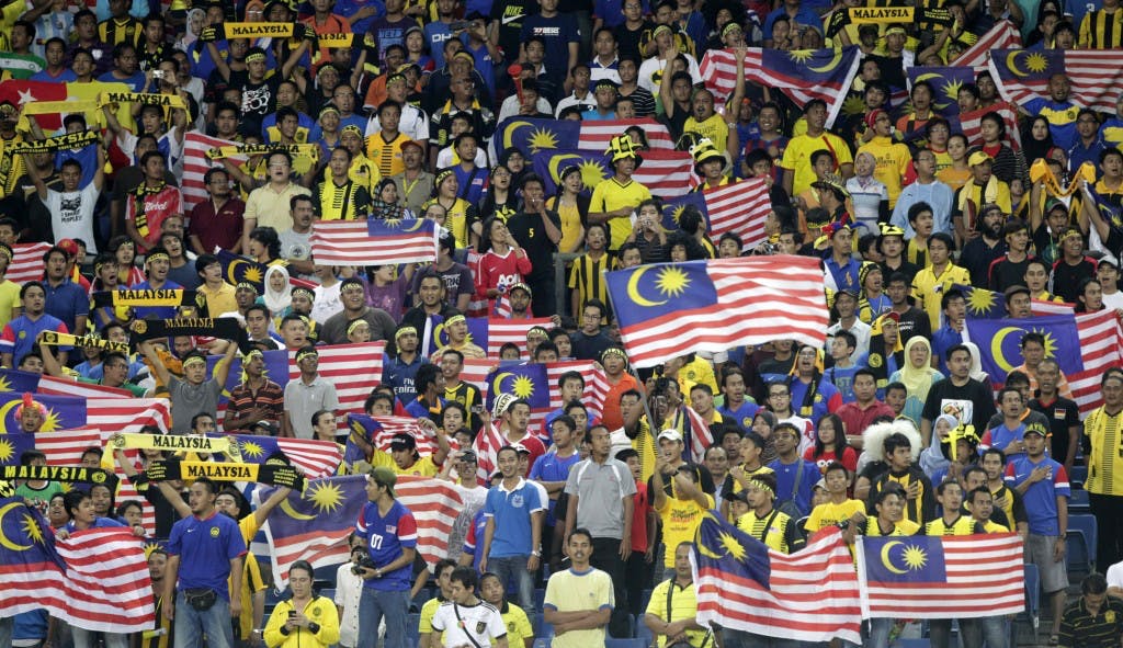 Malaysia fans wave Malaysian national flags in the stands before their semi-final first leg match of the ASEAN Football Federation (AFF) 2010 soccer tournament against Vietnam in Kuala Lumpur