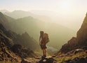 Hiker with Backpack on Mountain Landscape