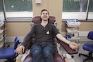 Man in chair smiling and giving blood