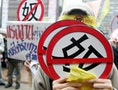 A protester holds a placard during a rally protesting against poor working conditions of foreign workers in Taipei