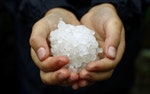 A youngster shows off a ball made from hail stones in south London