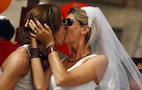 Lesbians kiss as they take part in the annual gay pride parade in downtown Rome