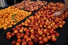 A man views stone fruits that have ripened early because of the drought, at a farmers market in Los Angeles