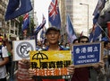 A protester carries a placard which reads "I need real universal suffrage" during a demonstration in Hong Kong