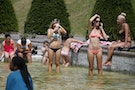 People cool off in the Trocadero fountains during a hot summer day in Paris