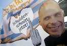 A demonstrator sporting the mask depicting former Greek Finance Minister Varoufakis takes part in a protest outside the European Central Bank headquarters in Frankfurt