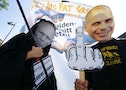 Demonstrators sporting the masks depicting German Finance Minister Schaeuble and former Greek Finance Minister Varoufakis take part in a protest outside the European Central Bank headquarters in Frank