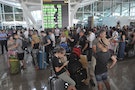 Passengers wait at the international departure terminal at Ngurah Rai Airport