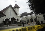 Soldiers stand guard outside a church after it was attacked by a mob in Temanggung