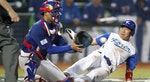 South Korea's Keunwoo slides to home base while Taiwan's Chih-kang catches the ball in the fifth inning at their WBC qualifying first round game in Taichung
