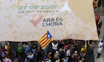 Catalan pro-independence supporters display a giant banner at Sant Jaume square in Barcelona