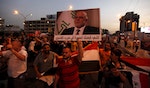 People shout slogans during a demonstration to show support for Iraqi Prime Minister al-Abadi at Tahrir Square in central Baghdad