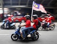"Red Shirt" demonstrators on motorcycles gather for a rally to celebrate Malaysia Day and to counter a massive protest held over two days last month that called for Prime Minister Najib's resignation 