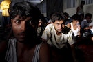Migrants, believed to be Rohingya, rest inside a shelter after they arrived in Indonesian by boat with Bangladeshi migrants in Kuala Langsa