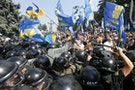 Demonstrators, who are against a constitutional amendment on decentralization, clash with police outside the parliament building in Kiev