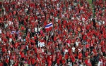 Red-shirted supporters attend a rally at Rajamangala national stadium in Bangkok