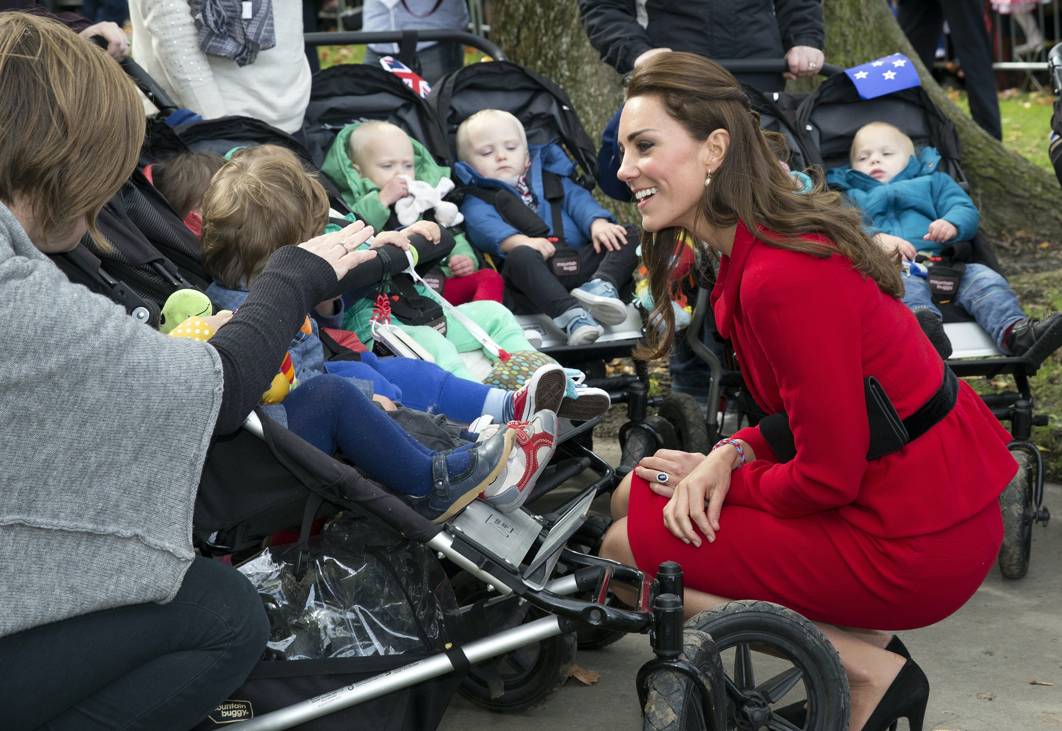 Britain's Catherine, the Duchess of Cambridge, talks with five sets of twins and their mothers during a walkabout in Christchurch