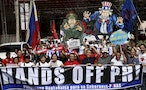 Activists chant slogans as they march in front of placards of a Chinese soldier and Uncle Sam as they march towards the Chinese Consulate during a protest over the South China Sea disputes with the Ph