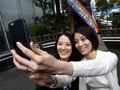 Hiroko Masuhara and her partner Koyuki Higashi take 'selfie' pictures in front of the statue of famous Japanese dog Hachiko after the ward office issuing the the nation's first same sex partnership ce