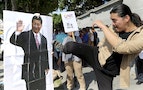 An activist kicks a portrait of Chinese President Xi Jinping during a protest against the upcoming meeting  between Taiwan's President Ma Ying-jeou and Chinese President Xi Jinping, in front of the Pr