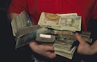 Person holding stack of burmese money, Rangoon, Myanmar