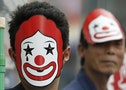 Demonstrators wearing masks depicting the mascot of McDonald's take part in a protest to demand higher wages for fast-food workers in Tokyo