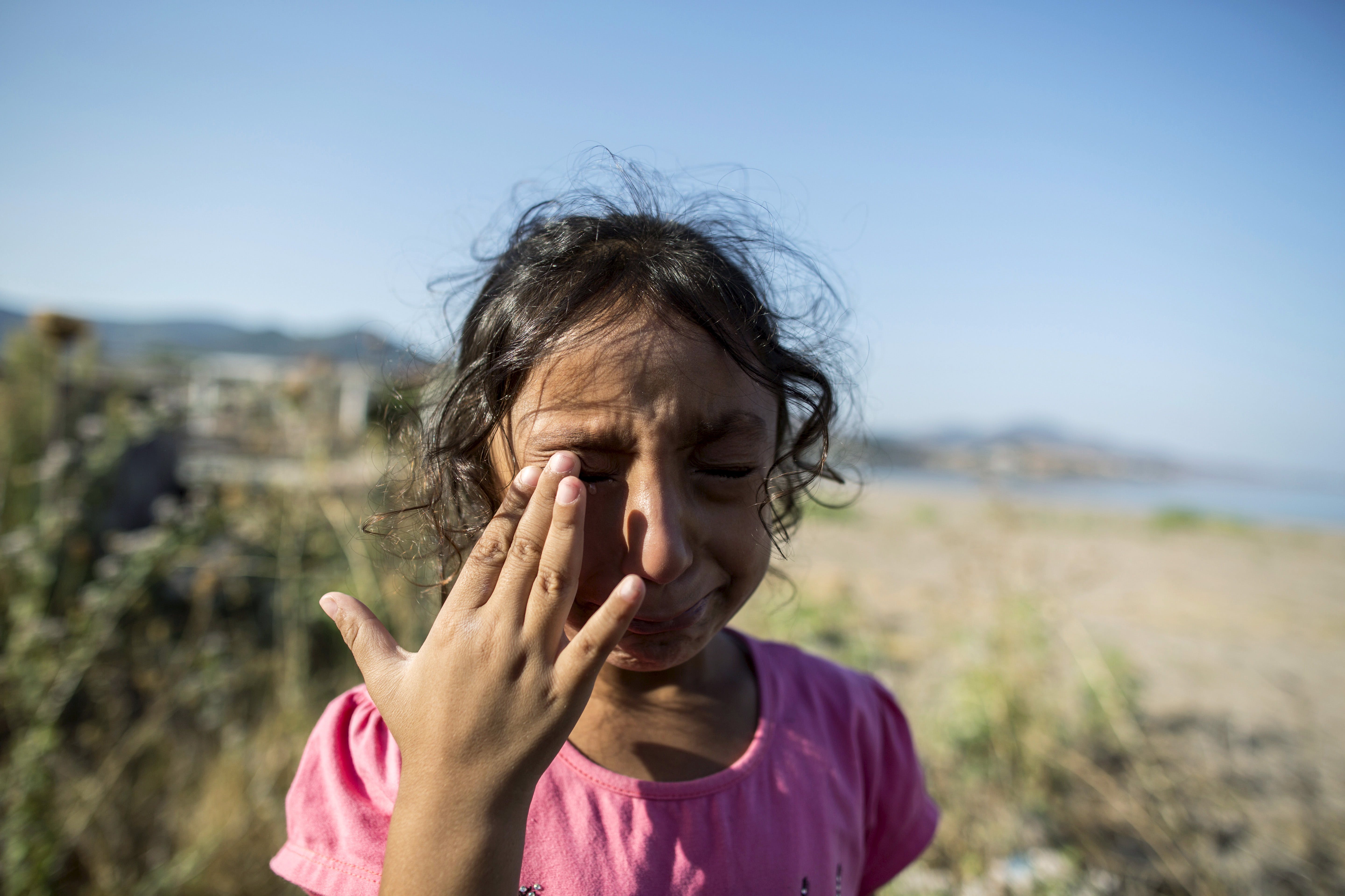Yasmine, a 6-year-old migrant from Deir Al Zour in war-torn Syria, cries at the beach after arriving on the Greek island of Lesbos